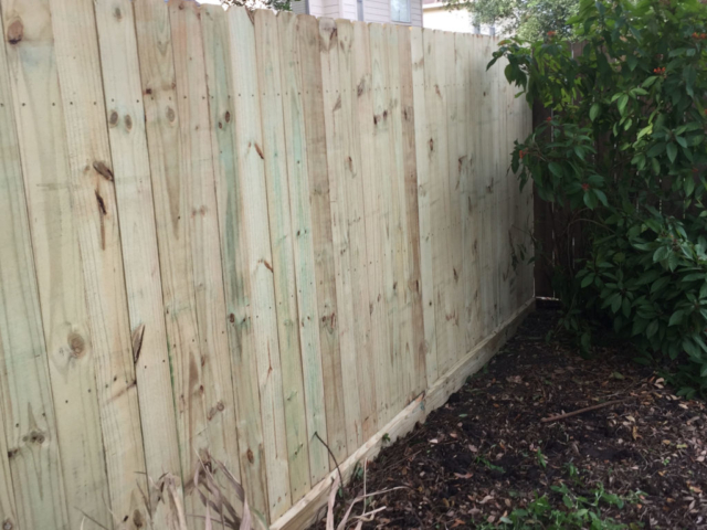 Pine Wood Fence with Beveled Rot Board Residential Installation